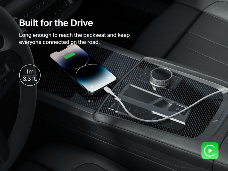 A Belkin BoostCharge Braided USB-A Cable with Lightning Connector powers an iPhone in a car, featuring a 1-meter (3.3 ft) length ideal for backseat charging and Apple CarPlay support.