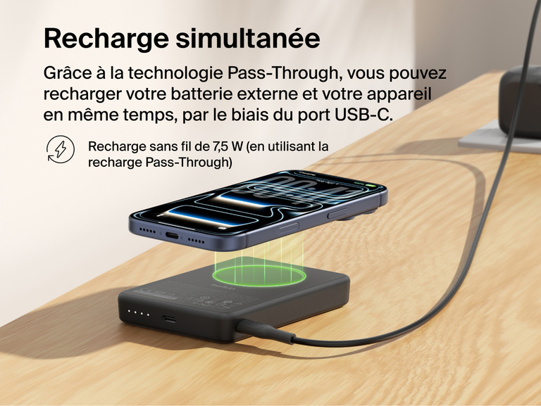 Belkin BoostCharge Slim Magnetic Power Bank 10K delivering pass-through charging with a smartphone wirelessly charging on top while the power bank recharges via USB-C cable
