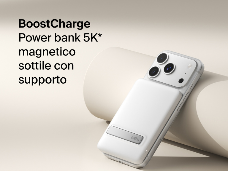 Belkin BoostCharge Slim Magnetic Power Bank 5K with Qi2 wirelessly attached to a smartphone, featuring a slim magnetic design with integrated card storage for portable on-the-go charging.