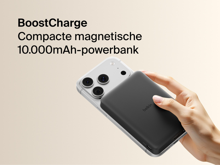 Belkin BoostCharge Slim Magnetic Power Bank 10K magnetically attached to iPhone, demonstrating secure wireless charging with a slim portable design