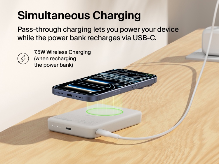 Belkin BoostCharge Slim Magnetic Power Bank 10K delivering pass-through charging with a smartphone wirelessly charging on top while the power bank recharges via USB-C cable