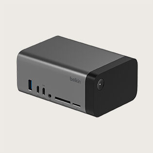 A Belkin docking station featuring various ports, including USB, HDMI, audio jack, and SD card slots. The docking station has a rectangular shape with a black front panel and metallic body, designed for versatile connectivity and efficient workspace organization.
