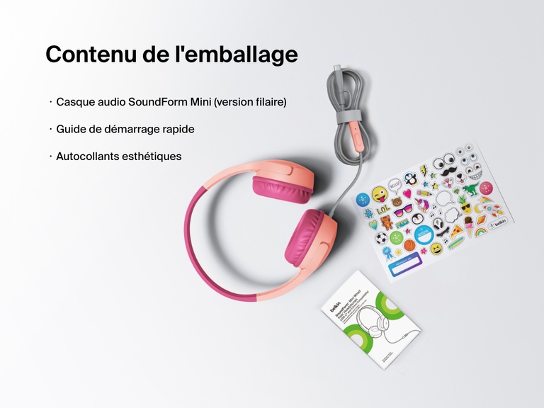 Flat lay image showing the contents of the Belkin SoundForm Mini Wired Headphones box, including the headphones, a quick start guide, and a sheet of decorative stickers.