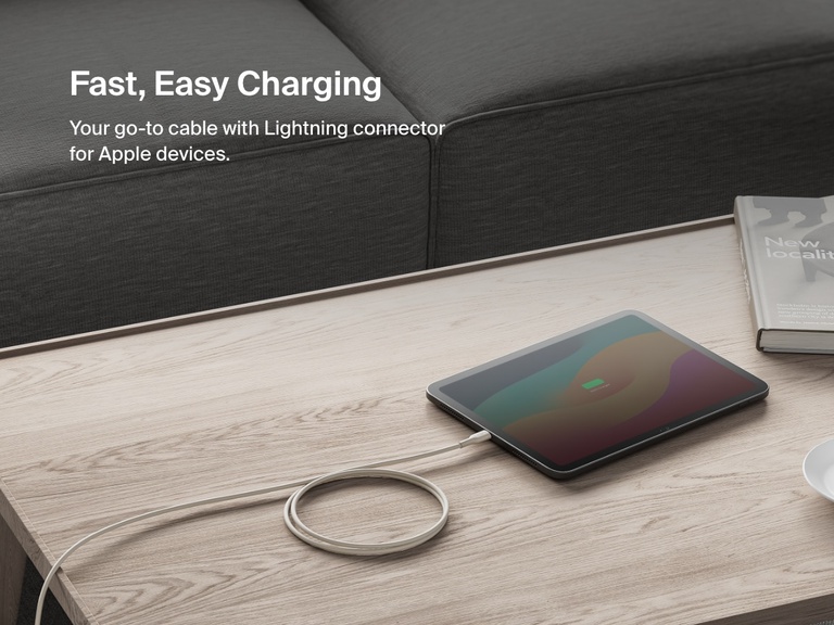 Belkin BoostCharge USB-C Cable with Lightning Connector shown charging an iPad on a coffee table, highlighting fast and easy charging for Apple devices.