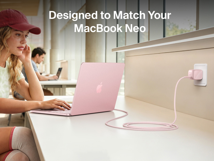 Person using a MacBook Neo connected to the Belkin BoostCharge Compact USB-C Charger 30W and braided USB-C cable at a study desk.