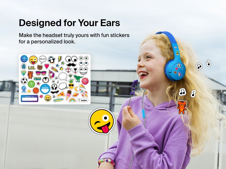 Smiling girl wearing Belkin Wired On-Ear Headphones for Kids decorated with colorful stickers, highlighting the headset’s personalization feature with included fun sticker sheet.