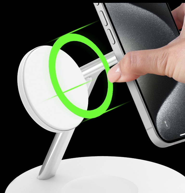 A hand placing a smartphone onto the Belkin BoostCharge Pro 3-in-1 Wireless Charging Stand with Qi2 15W.