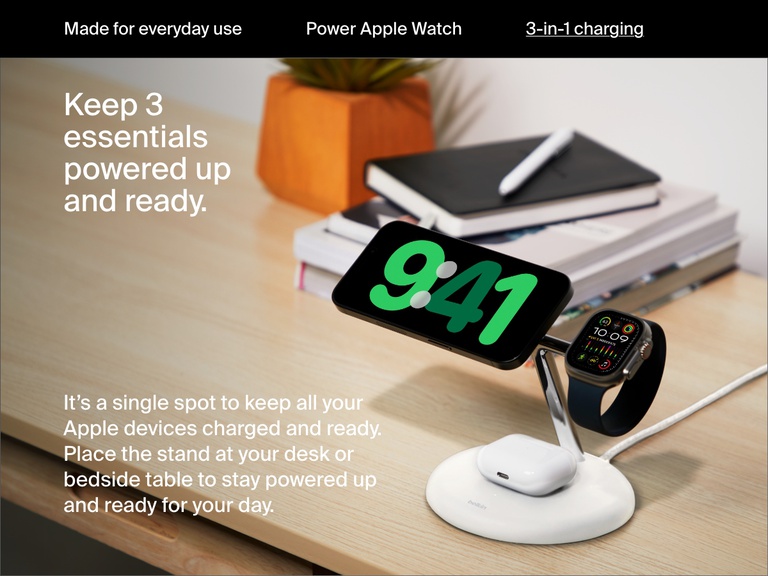 Image of a white Belkin BoostCharge Pro 3-in-1 Magnetic Wireless Charging Stand with Qi2 15W on a desk, simultaneously charging an iPhone, Apple Watch, and AirPods to keep essential devices powered and ready.