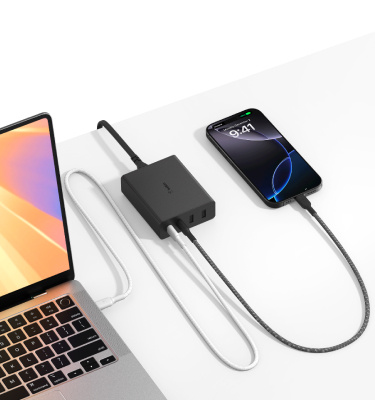 A MacBook an iPhone charge simultaneously using the Belkin Multi-Device GaN Charging Kit, featuring high-speed USB-C connectivity for efficient power delivery.