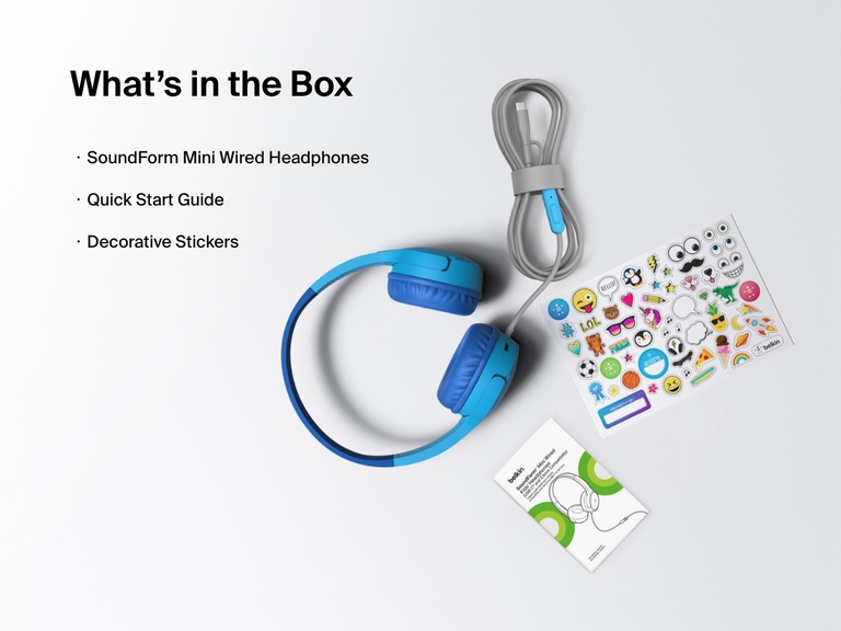Flat lay image showing the contents of the Belkin SoundForm Mini Wired Headphones box, including the headphones, a quick start guide, and a sheet of decorative stickers.