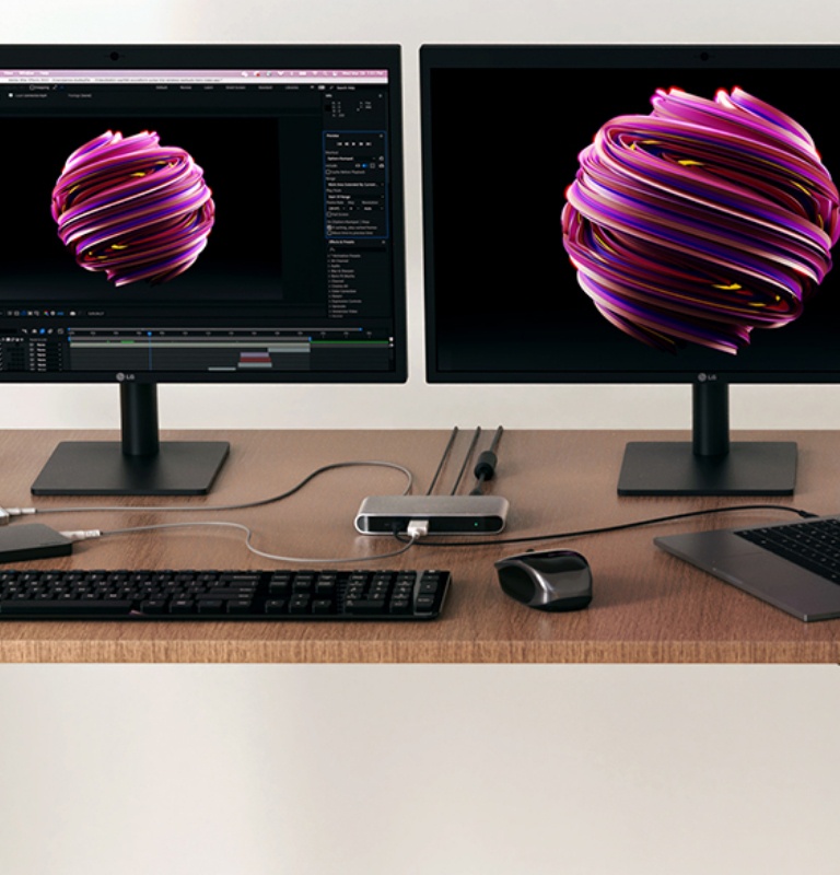 An image of a dual monitor workspace with both screens actively in use, laptop connected and opened to the right with Belkin Thunderbolt 4 5-in-1 Core Hub shown center in the mix.