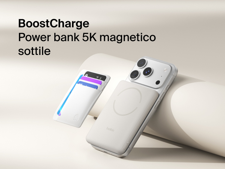 Belkin BoostCharge Slim Magnetic Power Bank 5K with Qi2 wirelessly attached to a smartphone, featuring a slim magnetic design with integrated card storage for portable on-the-go charging.