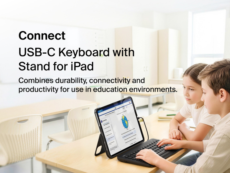 USB-C Keyboard for iPad shown with two children using it at a classroom desk, with on-image text Combines durability, connectivity and productivity for use in education environments