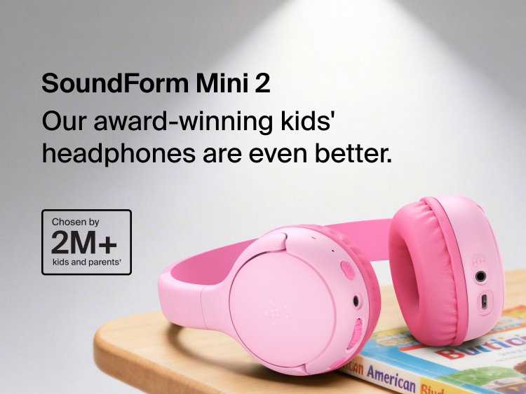SoundForm Mini 2 Wireless On-Ear Headphones for Kids resting on a wooden surface beside a children's book, with on-image text reading Our award-winning kids' headphones are even better and Chosen by 2M+ kids and parents