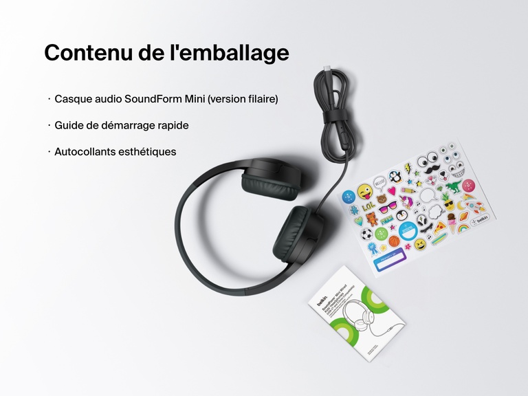 Flat lay image showing the contents of the Belkin SoundForm Mini Wired Headphones box, including the headphones, a quick start guide, and a sheet of decorative stickers.