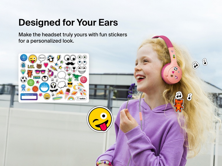 Smiling girl wearing Belkin Wired On-Ear Headphones for Kids decorated with colorful stickers, highlighting the headset’s personalization feature with included fun sticker sheet.