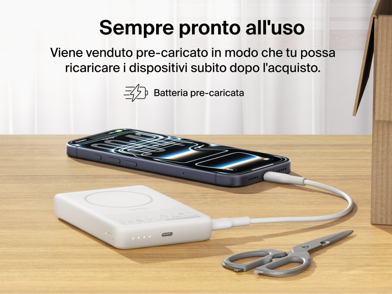 Belkin BoostCharge Slim Magnetic Power Bank 10K precharged out of the box powering a smartphone via USB-C cable with portable battery placed on a desk