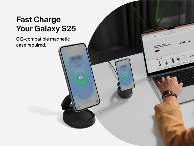Belkin BoostCharge 2-in-1 Convertible Magnetic Charging Stand with Qi2 15W shown fast charging a Galaxy S25 in a Qi2-compatible magnetic case at a desktop workspace.