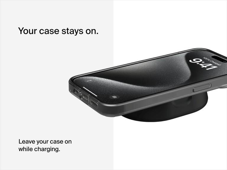 A black Belkin BoostCharge Pro Convertible Magnetic Wireless Charging Stand with Qi2 15W charges a cased iPhone lying flat, emphasizing compatibility with phone cases during charging.