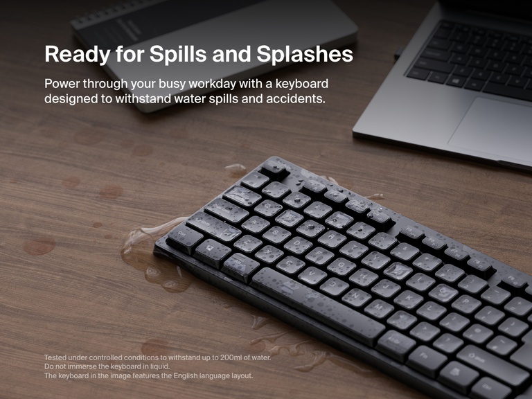 A Belkin Connect wireless keyboard is shown with water droplets on the keys and surface, demonstrating its spill-resistant design for everyday durability.