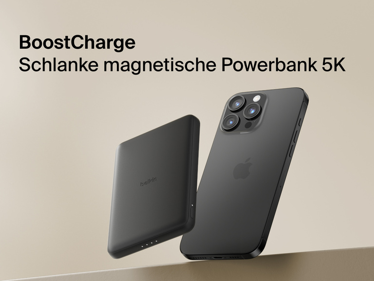 Belkin BoostCharge Slim Magnetic Power Bank 5K shown magnetically attached to a smartphone beside a slim wallet accessory, highlighting its compact portable charging design.