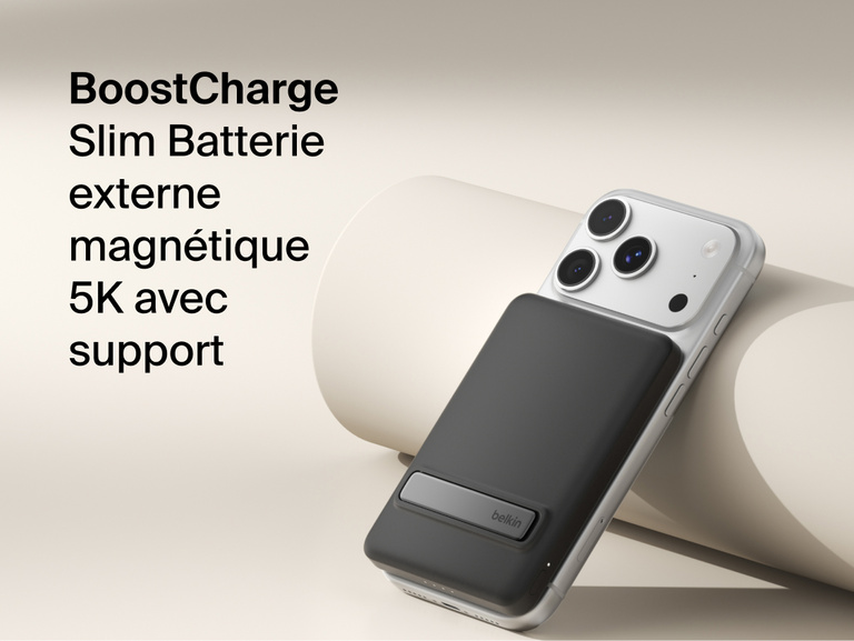 Belkin BoostCharge Slim Magnetic Power Bank 5K with Qi2 wirelessly attached to a smartphone, featuring a slim magnetic design with integrated card storage for portable on-the-go charging.