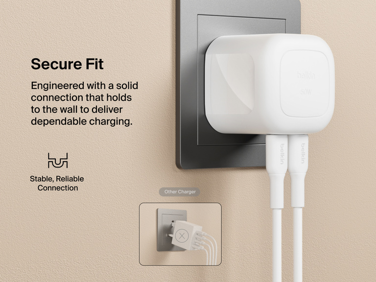 Belkin BoostCharge Pro Dual USB-C GaN Wall Charger 50W plugged securely into a wall outlet with dual cables connected, designed for a stable, reliable fit compared to other chargers.
