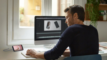 Man sitting at desk looking at computer monitor