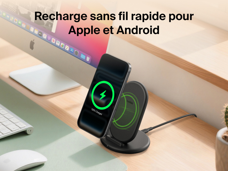 Belkin BoostCharge Wireless Charging Stand 15W shown charging a smartphone on a desk, compatible with both Apple and Android devices.