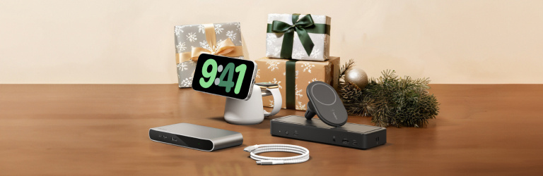 Belkin holiday tech gifts including chargers, docks, and accessories arranged on a wooden surface with wrapped presents and festive decor.