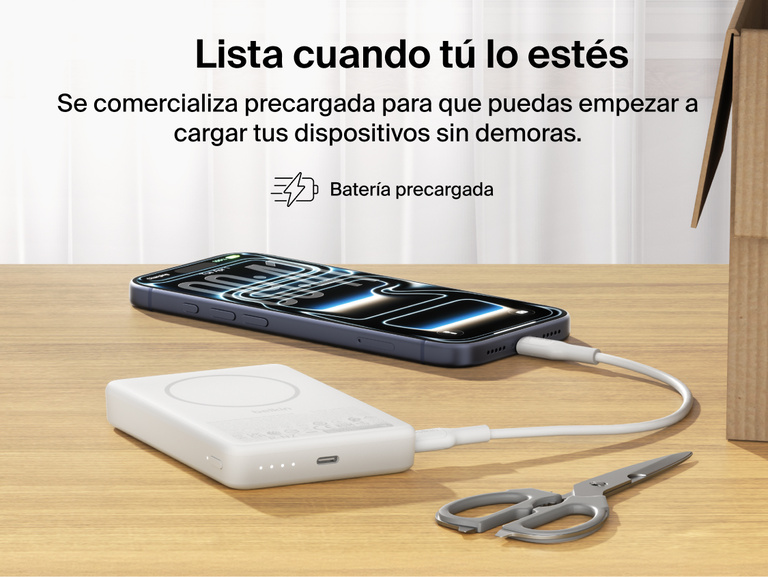 Belkin BoostCharge Slim Magnetic Power Bank 10K precharged out of the box powering a smartphone via USB-C cable with portable battery placed on a desk