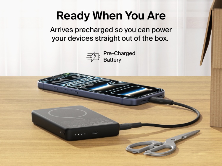Belkin BoostCharge Slim Magnetic Power Bank 10K precharged out of the box powering a smartphone via USB-C cable with portable battery placed on a desk