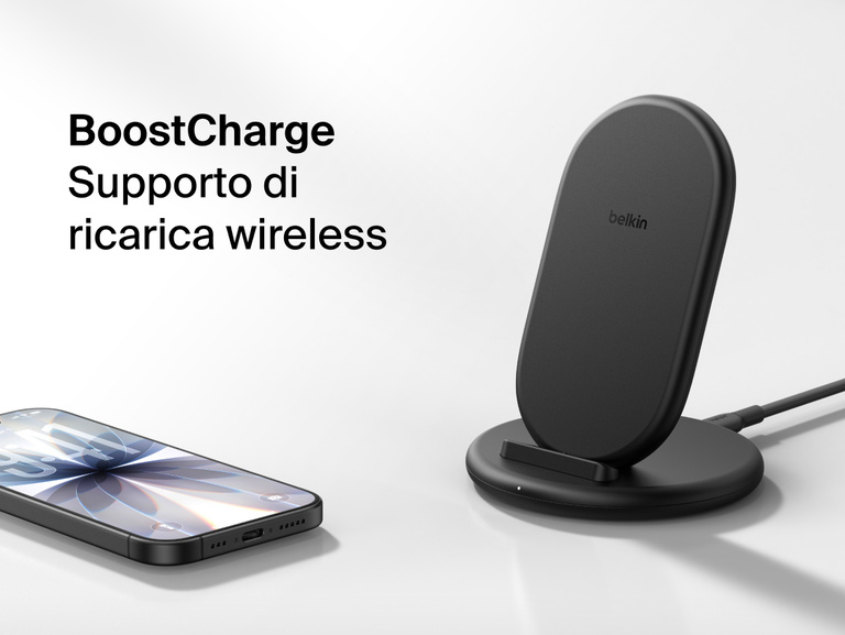 Belkin BoostCharge Wireless Charging Stand 15W shown with smartphone nearby, featuring a sleek upright design for fast wireless charging.