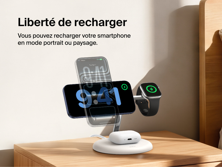 Belkin UltraCharge 3-in-1 Wireless Charging Stand with Qi2 25W charging iPhone in portrait and landscape modes alongside Apple Watch and AirPods on a bedside table