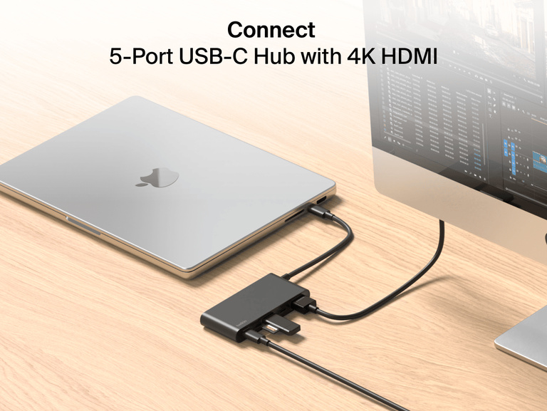 Belkin Connect 5-Port USB-C Hub with 4K HDMI links a MacBook to an external monitor and multiple devices on a wooden desk.