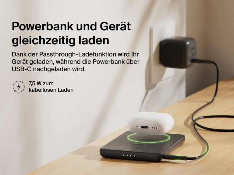 Belkin BoostCharge Slim Magnetic Power Bank 5K shown wirelessly charging earbuds while recharging via USB-C, demonstrating 7.5W pass-through charging functionality.