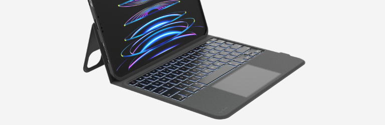 A sleek tablet with a detachable backlit keyboard and kickstand, displayed open on a light gray background, showing colorful digital waves on its screen.
