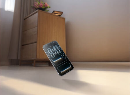Smartphone mid-air in a falling motion toward a hard floor, with a wooden dresser and flowers in the background, illustrating drop protection. Smartphone mid-air in a falling motion toward a hard floor, with a wooden dresser and flowers in the background, illustrating drop protection.