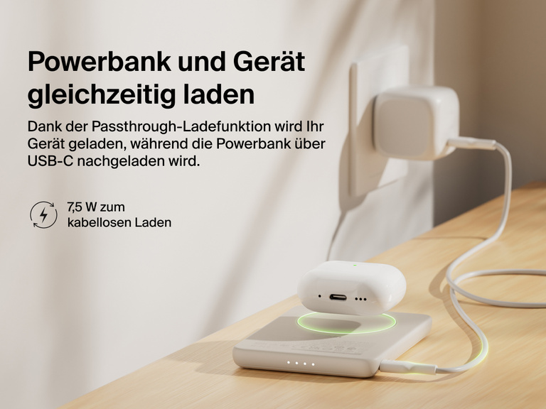 Belkin BoostCharge Slim Magnetic Power Bank 5K shown wirelessly charging earbuds while recharging via USB-C, demonstrating 7.5W pass-through charging functionality.