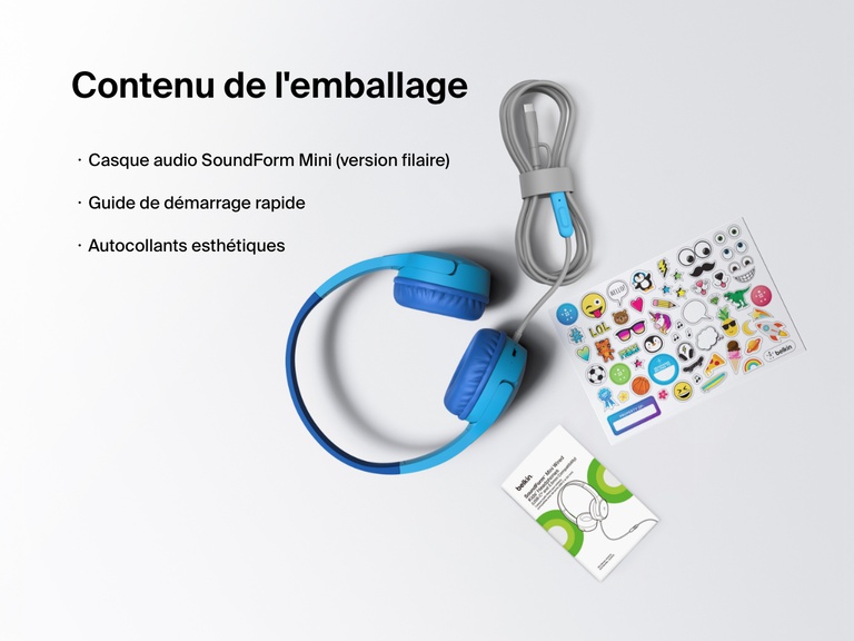 Flat lay image showing the contents of the Belkin SoundForm Mini Wired Headphones box, including the headphones, a quick start guide, and a sheet of decorative stickers.