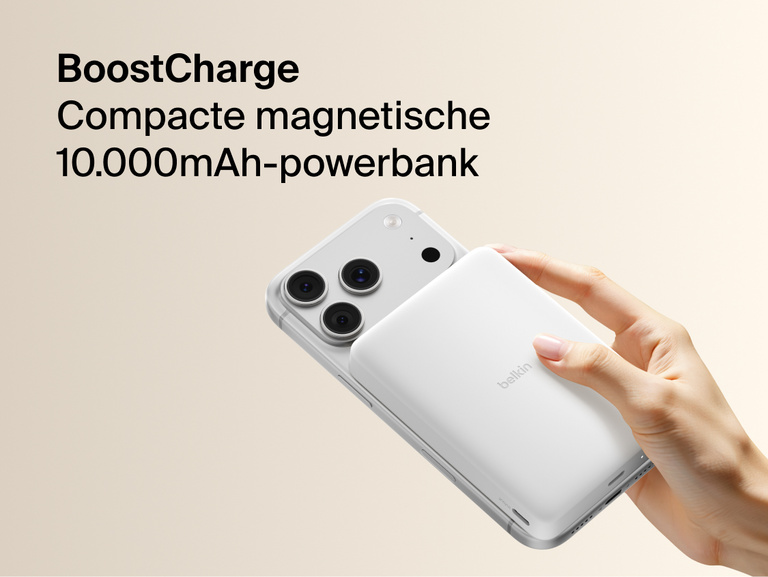 Belkin BoostCharge Slim Magnetic Power Bank 10K magnetically attached to iPhone, demonstrating secure wireless charging with a slim portable design