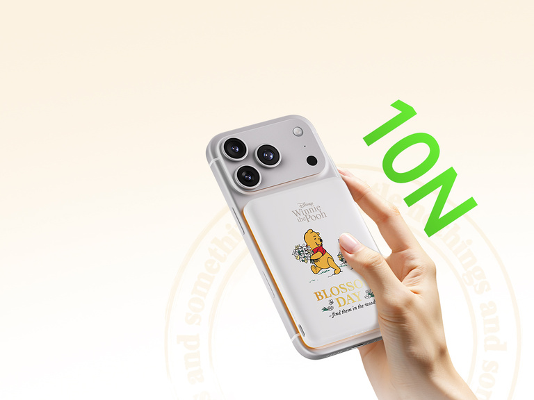 Belkin BoostCharge Slim Magnetic Power Bank 5K shown charging a smartphone and wireless earbuds simultaneously, demonstrating dual charging with 7.5W USB-C and 5W wireless shared power output.