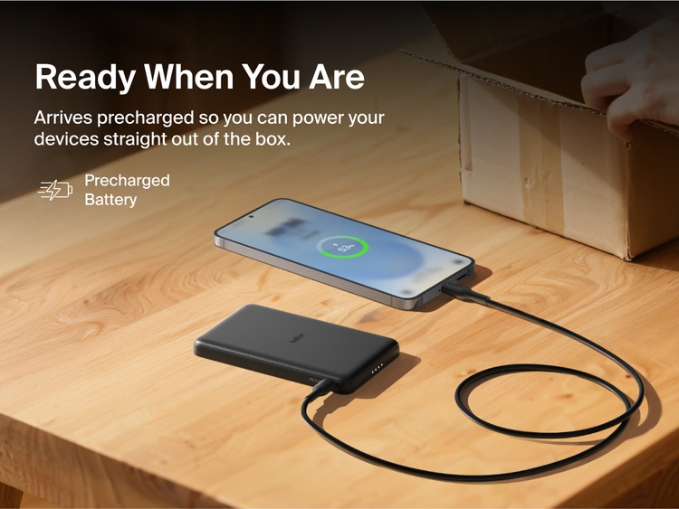 Belkin BoostCharge Slim Magnetic Power Bank 5K shown charging a smartphone on a table, highlighting its precharged battery ready for instant use out of the box.