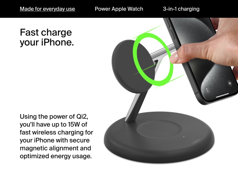 Image of a hand placing an iPhone onto a black Belkin BoostCharge Pro 3-in-1 Magnetic Wireless Charging Stand with Qi2 15W, illustrating secure magnetic alignment and fast charging up to 15W using Qi2 technology.
