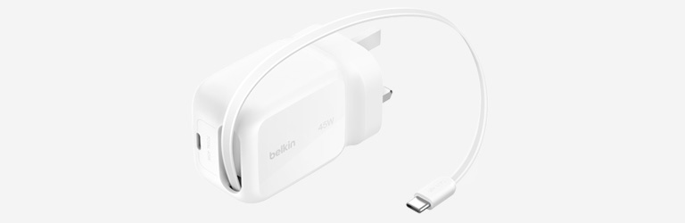 Close-up image of a Belkin GaN charger with two USB-C ports and foldable prongs.