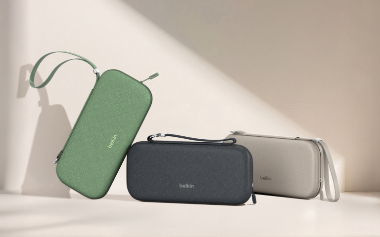 Three rectangular Belkin-branded carrying cases are displayed in a minimalist setting with soft lighting. The cases are arranged side by side in green, black, and beige colors, each with a matching wrist strap. The cases are standing upright or slightly tilted, casting shadows on a light-colored surface and wall, emphasizing their sleek, modern design. Three rectangular Belkin-branded carrying cases are displayed in a minimalist setting with soft lighting. The cases are arranged side by side in green, black, and beige colors, each with a matching wrist strap. The cases are standing upright or slightly tilted, casting shadows on a light-colored surface and wall, emphasizing their sleek, modern design.