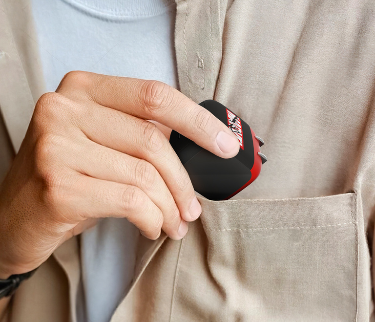 A person places a Belkin BoostCharge Compact USB-C Wall Charger 45W into the front pocket of a beige shirt.