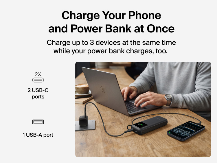 UltraCharge Power Bank 11K with Retractable Cable charging a laptop and a phone at a desk at the same time using its retractable cable, USB-C ports, and USB-A port