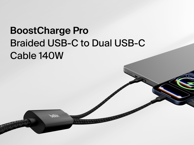 Belkin BoostCharge Pro braided USB-C to dual USB-C cable delivering up to 140W fast charging, shown powering a smartphone and laptop simultaneously.