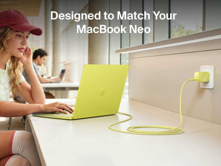 Person using a MacBook Neo connected to the Belkin BoostCharge Compact USB-C Charger 30W and braided USB-C cable at a study desk.